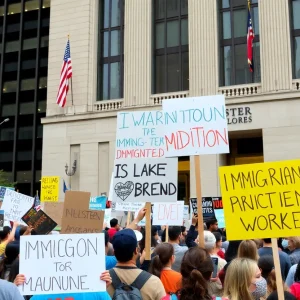 Crowd of protesters holding signs in Chicago against immigration enforcement