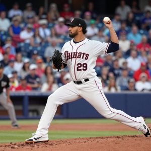 A pitcher throwing a baseball with a crowd in the background