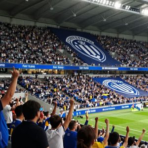 Fans cheering at Sporting Kansas City stadium for their new coach.