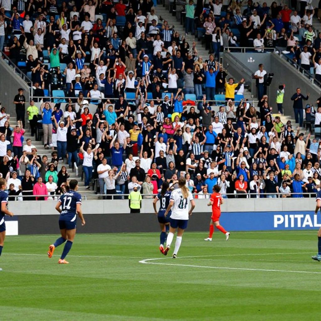 Fans celebrating at Teal Rising Week women's soccer match